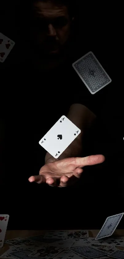 Mystical hand with floating playing cards on dark background.