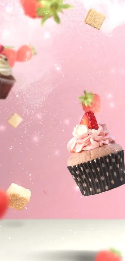 Floating cupcakes and strawberries on a pink background.