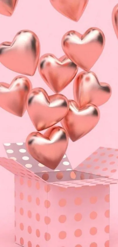 Rose gold hearts emerging from a pink dotted gift box.