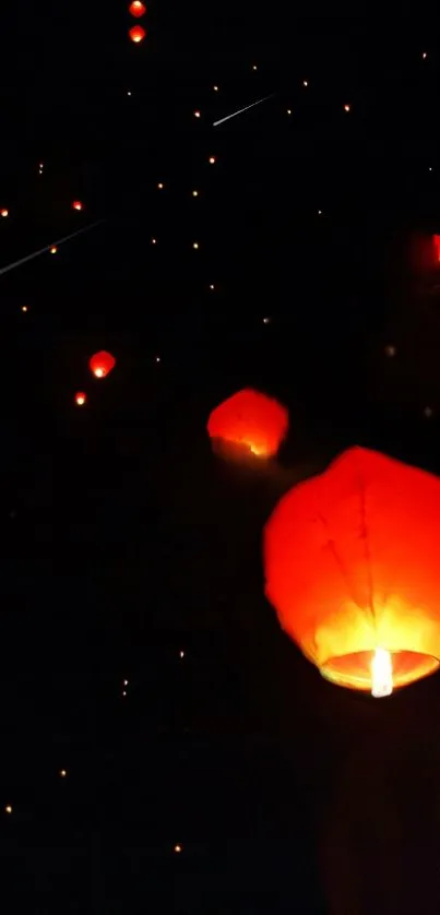 Red lanterns float in a dark, star-speckled sky, emanating a warm, tranquil glow.