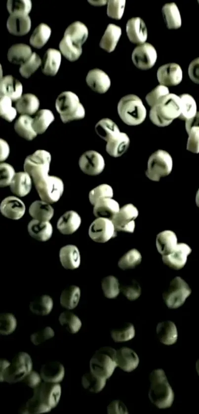 Floating letter beads on a black background, creating an artistic and abstract wallpaper.