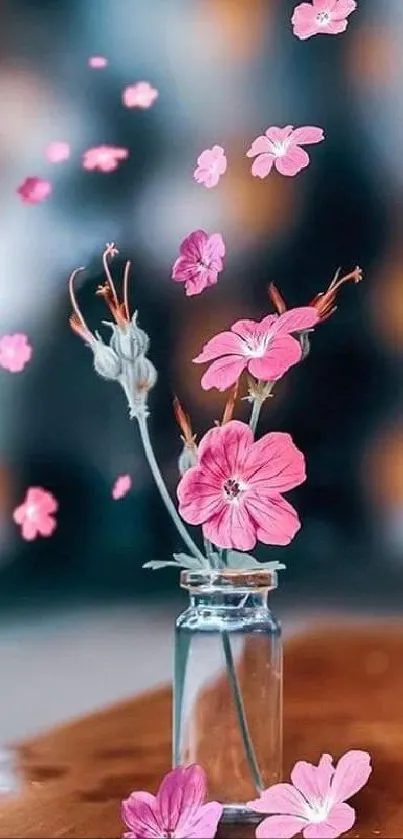 Floating pink flowers in a small vase against a blurred background.