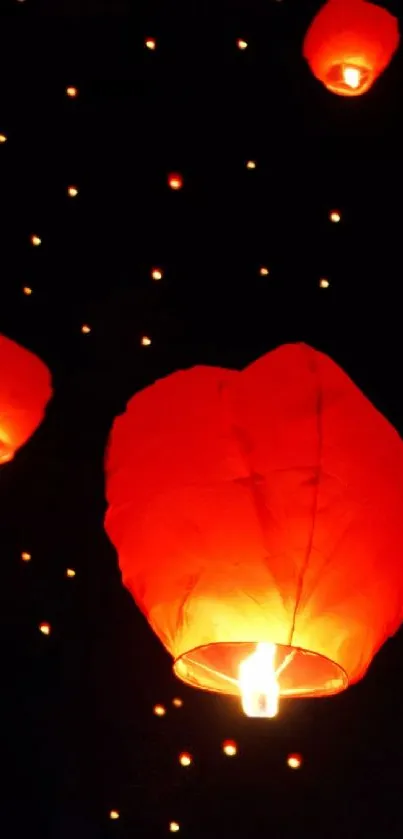 Red lanterns glowing against a starry night sky.