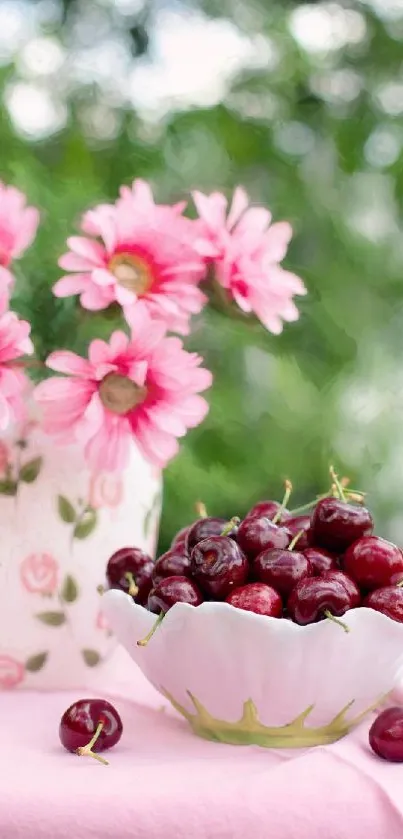 Vibrant wallpaper with pink flowers and cherries in a bowl.