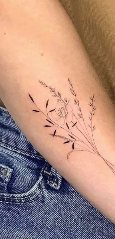 Floral arm tattoo with botanical line art on a beige background.