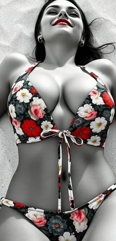 Woman in floral bikini lying on sandy beach.