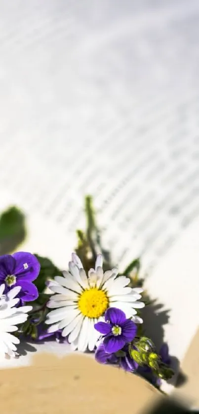 Mobile wallpaper with daisies and violets on an open book.