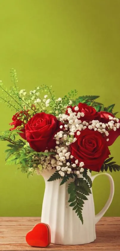 Red rose bouquet in white vase against green background.