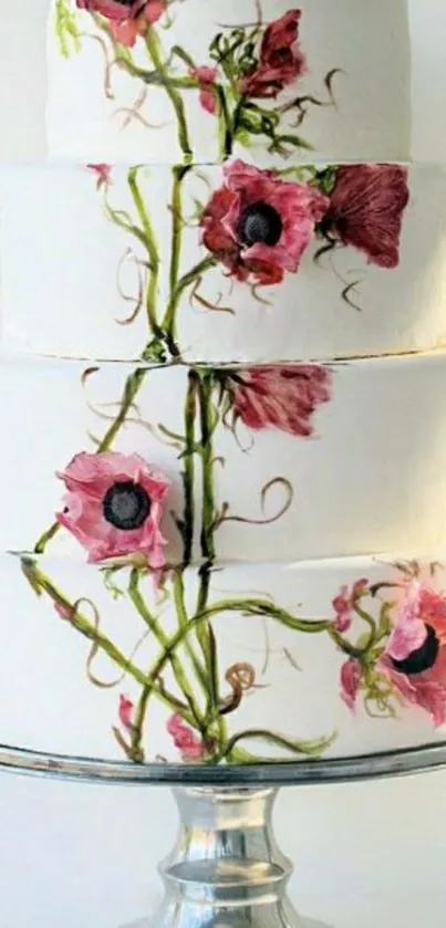 Three-tier cake with pink floral designs on white background.