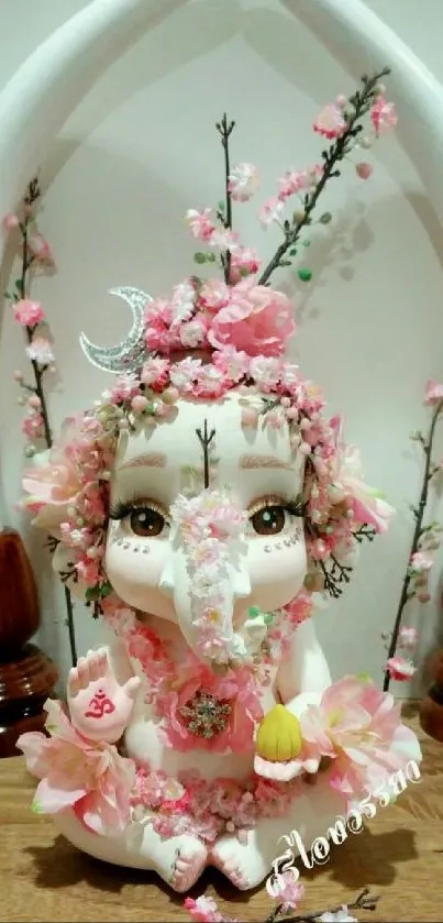 Floral statue of Ganesh with pink decor and ornate details.