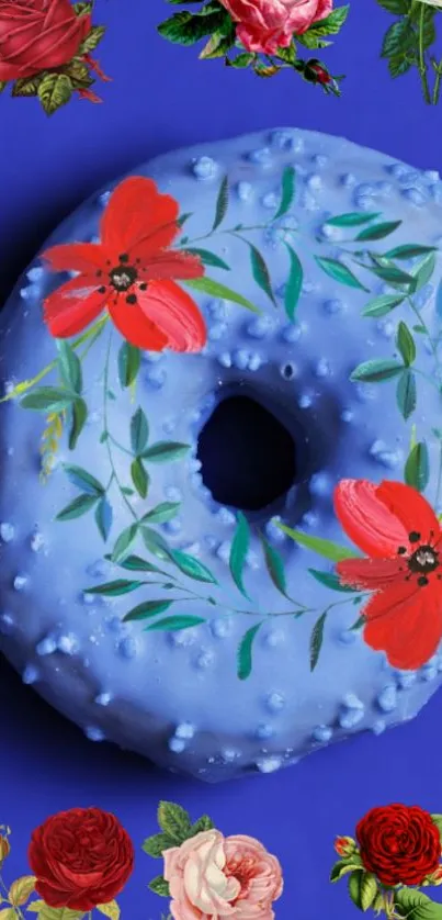 Blue floral donut with red flowers on dark blue background.