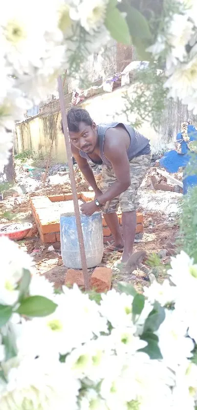 Construction scene framed by white flowers.