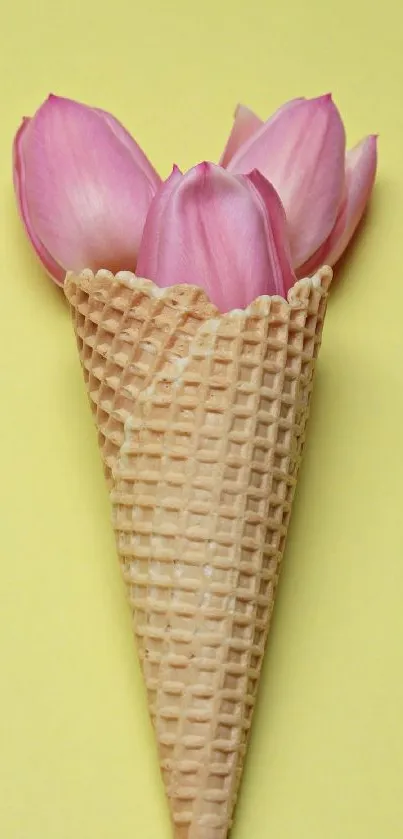 Ice cream cone filled with pink flowers on yellow background.