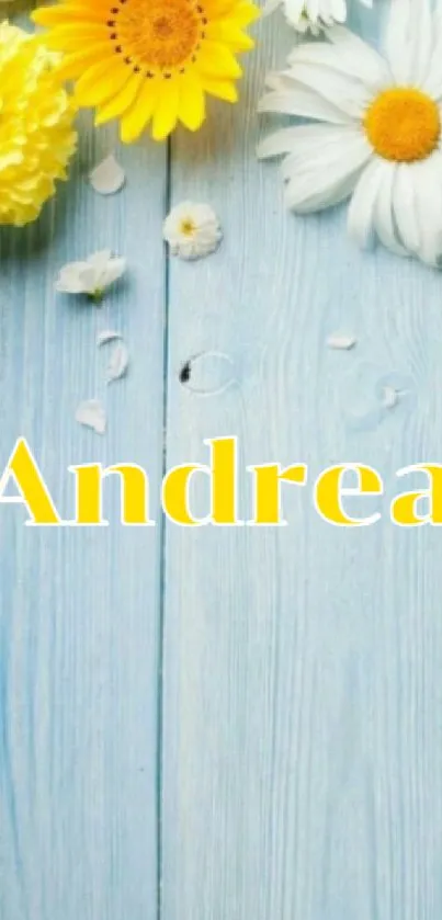 Mobile wallpaper with yellow daisies and name 'Andrea' on a blue wood background.