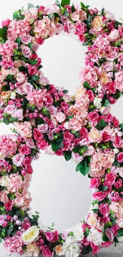 Number 8 made of vibrant pink roses and green leaves, floral design.