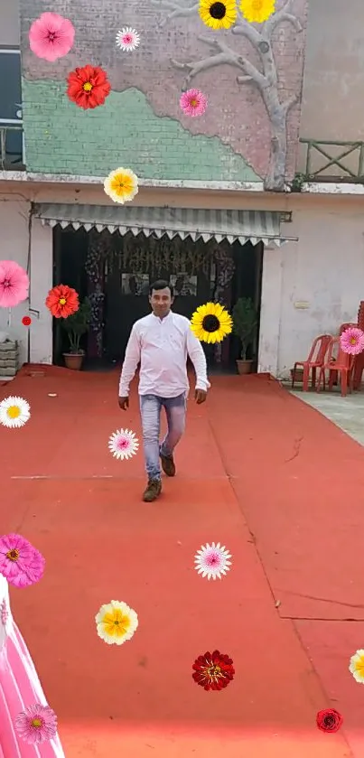 Man walking on red carpet with colorful flowers.