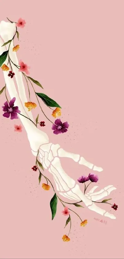 Skeletal hand entwined with colorful flowers against pink.