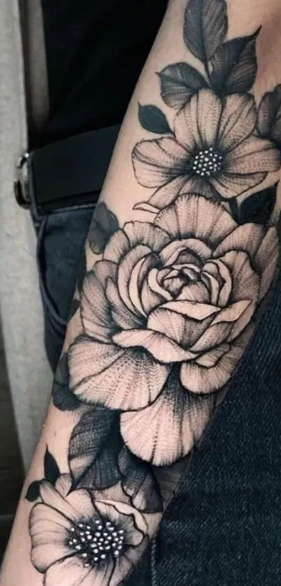 Black and white floral tattoo on an arm, showcasing intricate design.