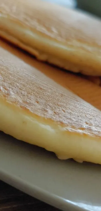 Close-up of fluffy pancakes on a plate.