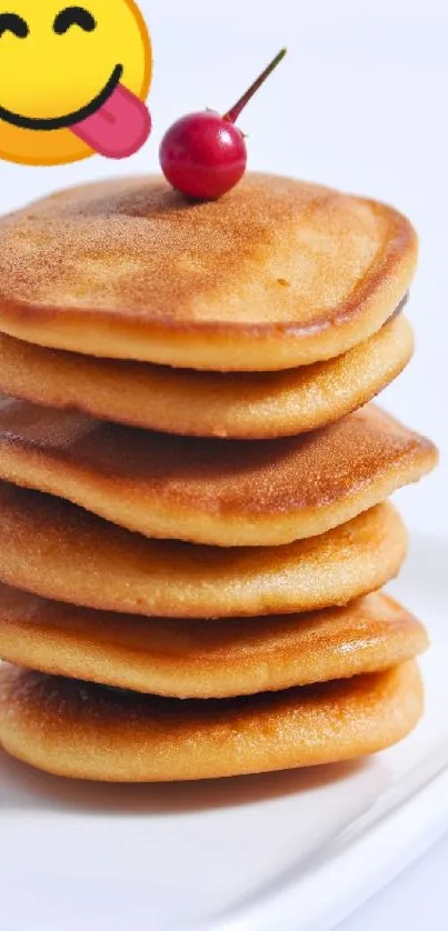 Stack of pancakes with berry and emoji on a plate.