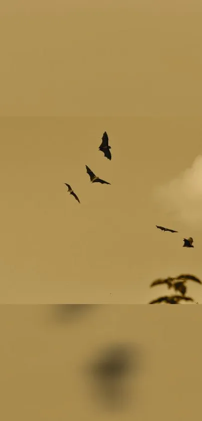 Flying bats in a sepia sky with scattered clouds.