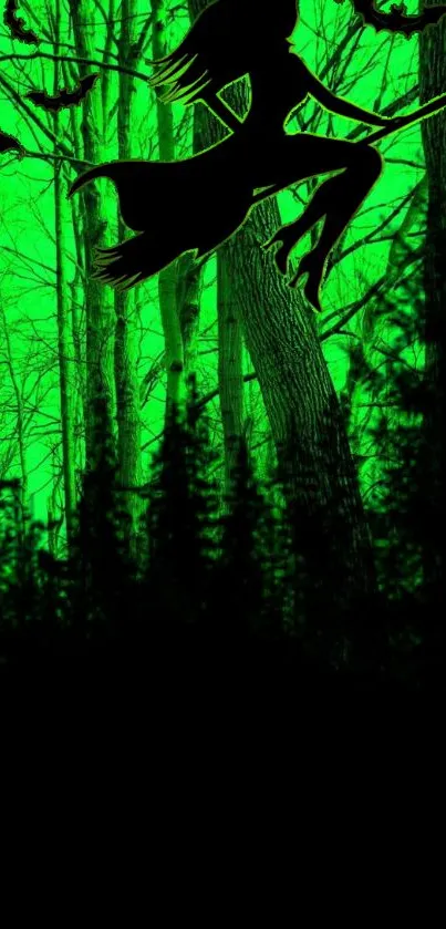 Silhouette of a witch flying over a green, mystical forest at night.