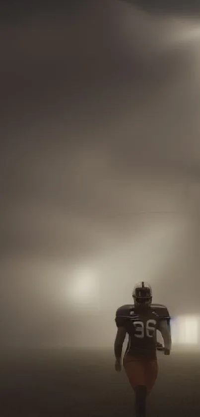 Foggy football field with lone player at night.