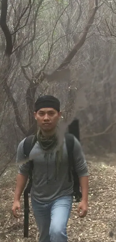 Hiker walking through foggy forest, creating a serene and adventurous ambiance.