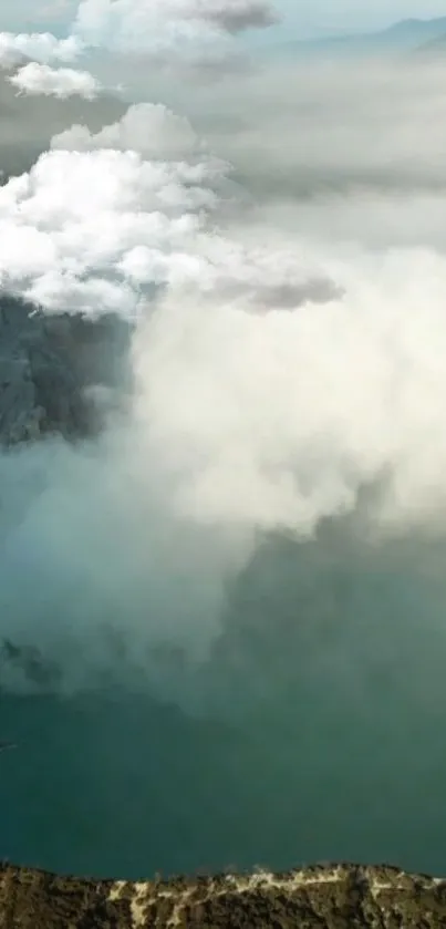 Foggy mountain lake with surrounding clouds.