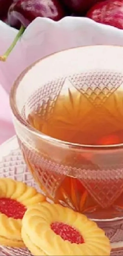 Crystal cup of tea with cookies and cherries on a light pink background.