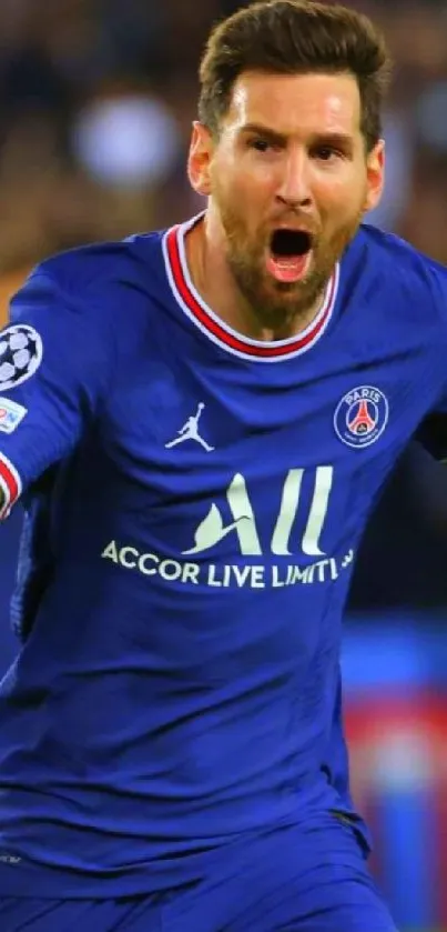 Footballer in blue jersey celebrating a goal in front of cheering crowd.