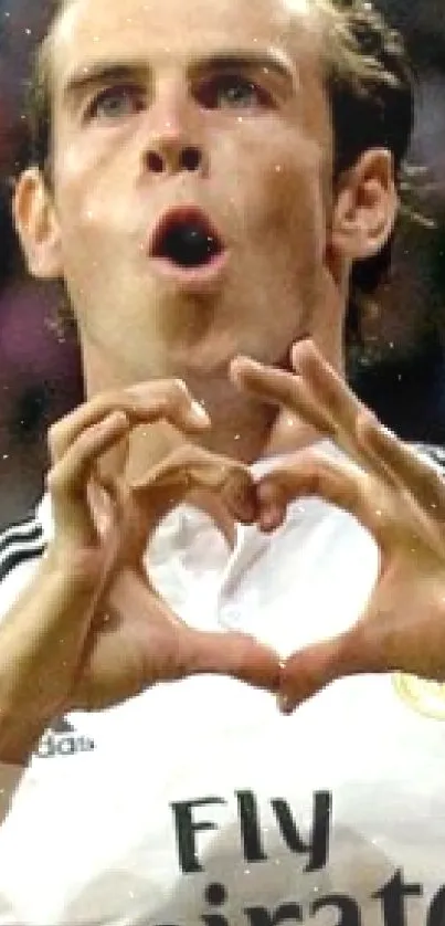 Football player making heart gesture in celebration.