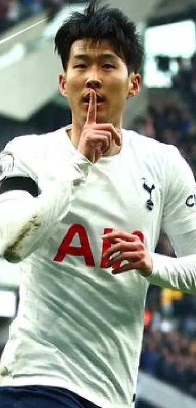 Football player making a 'shush' gesture during a thrilling match.