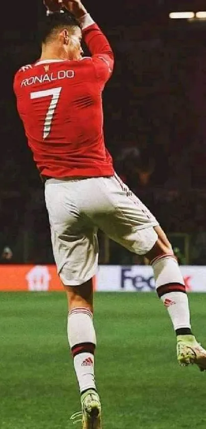 Football player in red jersey celebrating on the field.