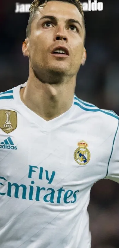 Football player in white Real Madrid jersey on field.