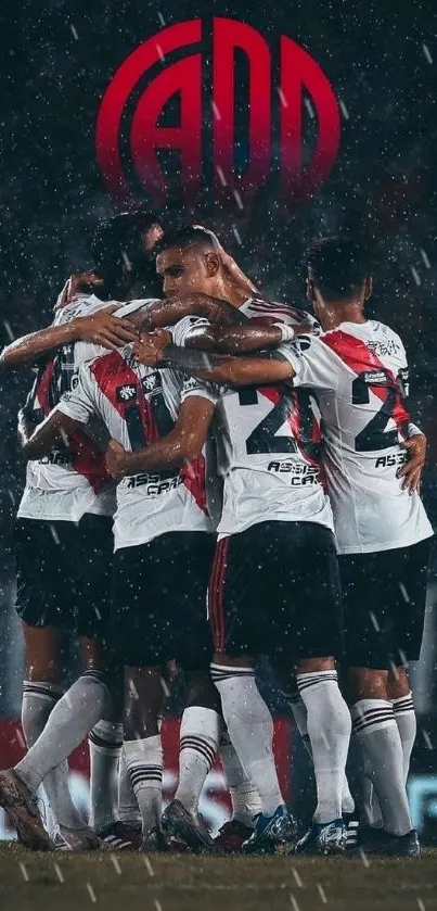 Soccer team huddle in rain, wearing white jerseys, showcases unity.