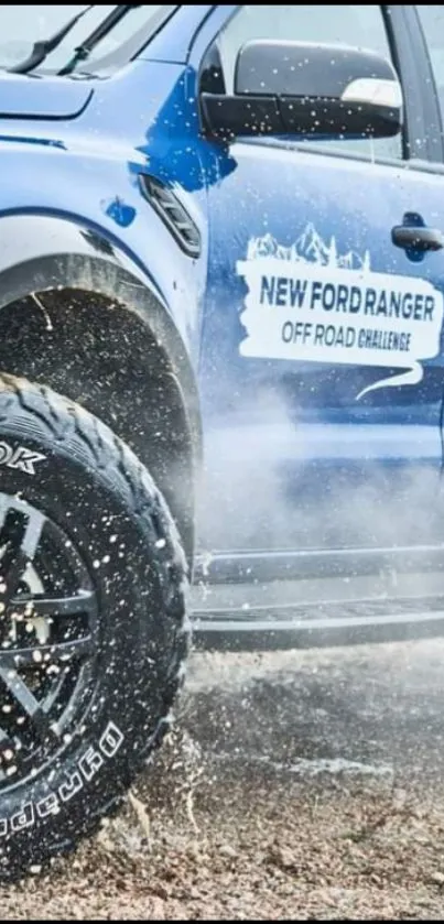 Blue Ford Ranger driving through terrain with splashing water.