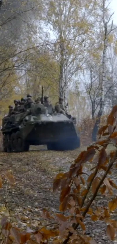 Armored vehicle on an autumn forest path with vibrant fall leaves.