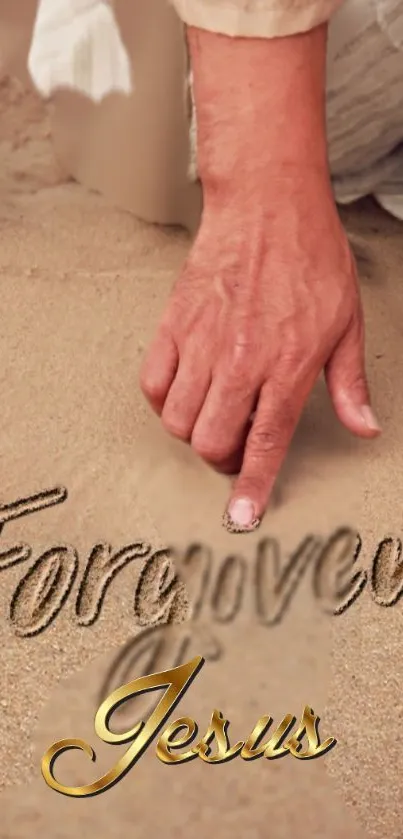 Hand writing 'Forgiven' in sand with 'Jesus' text below.