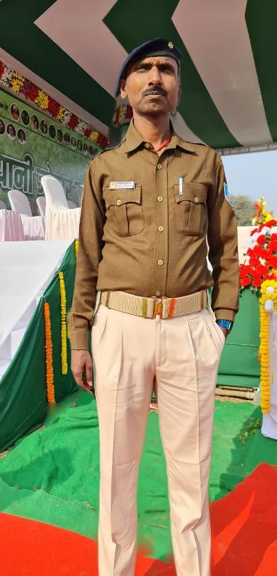 Uniformed man stands at a formal event in bright, outdoor setting with colorful decor.