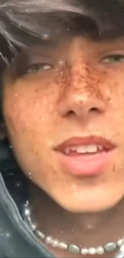 Freckled face close-up portrait with hoodie in natural light.