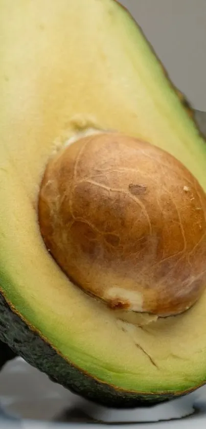 Close-up of a sliced avocado revealing seed and creamy texture.