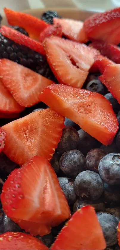 A vibrant mix of fresh strawberries, blueberries, and blackberries.