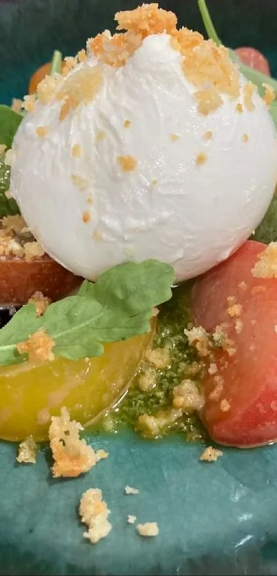 Burrata salad with vibrant tomatoes on a teal plate.