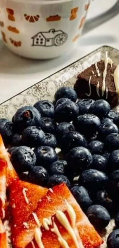 Fruit platter with berries and coffee cup on a cozy table.