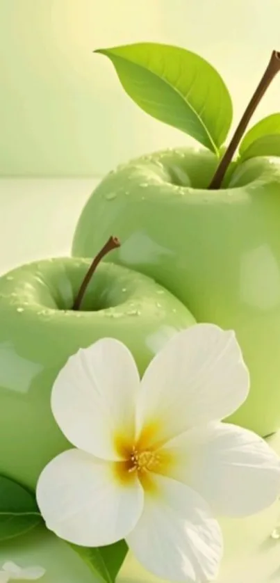 Vibrant green apples with a white flower.