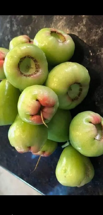 Fresh green fruit on dark background wallpaper.