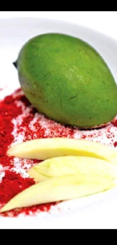 Green mango with red spices on white plate.