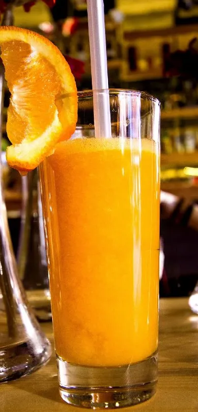 Vibrant orange juice in a glass with slice garnish, set in a lively background.