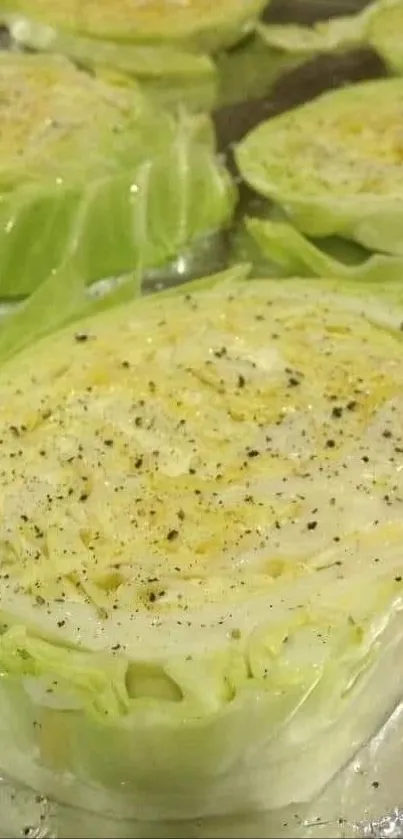 Freshly sliced cabbage on a baking tray, ready for cooking.